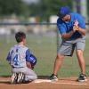 A coach training a baseball player